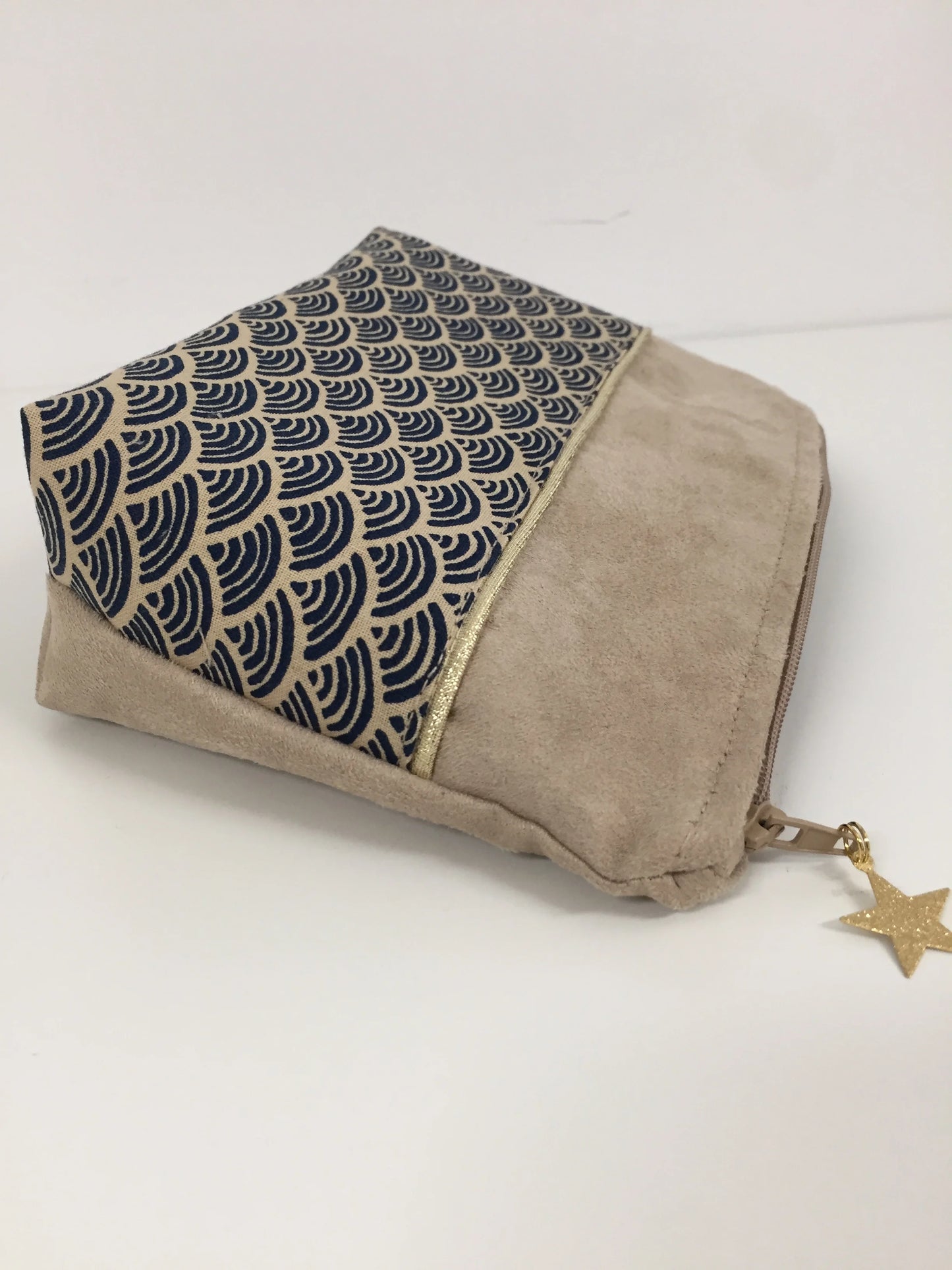 Vue de coté de la pochette à maquillage beige en tissu japonais Seigaiha bleu marine
