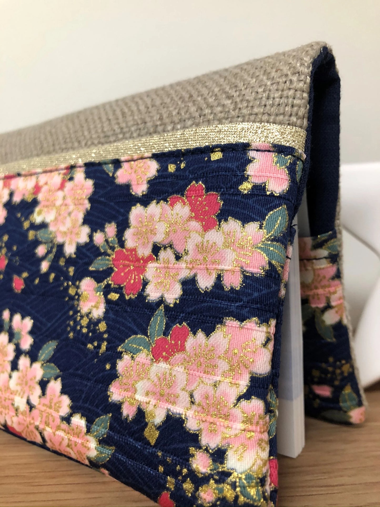 Vue détaillée du tissu japonais sur le porte-chéquier en lin beige et tissu japonais fleuri Sakura.