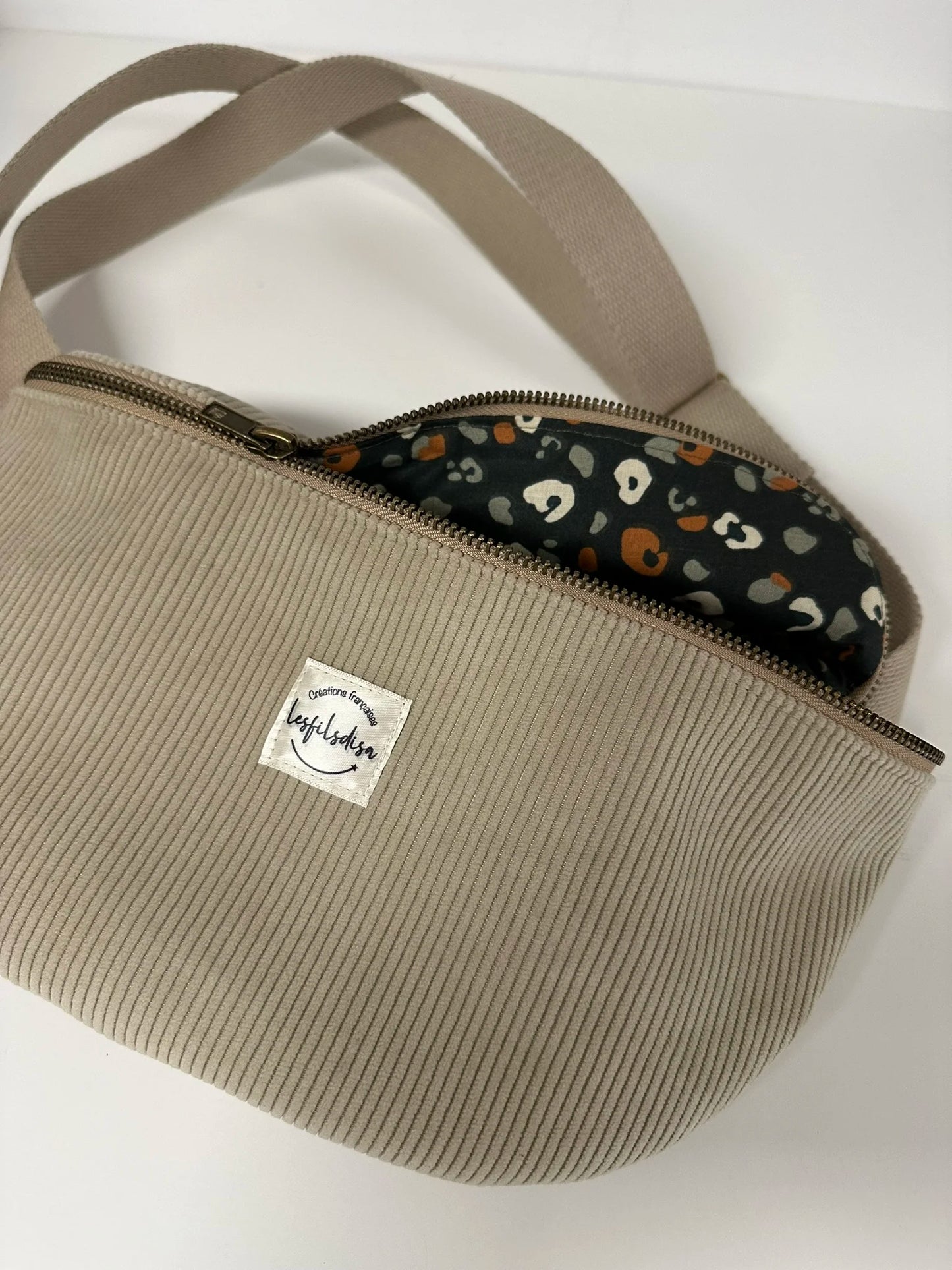 La doublure intérieure du sac banane en velours cotelé beige.