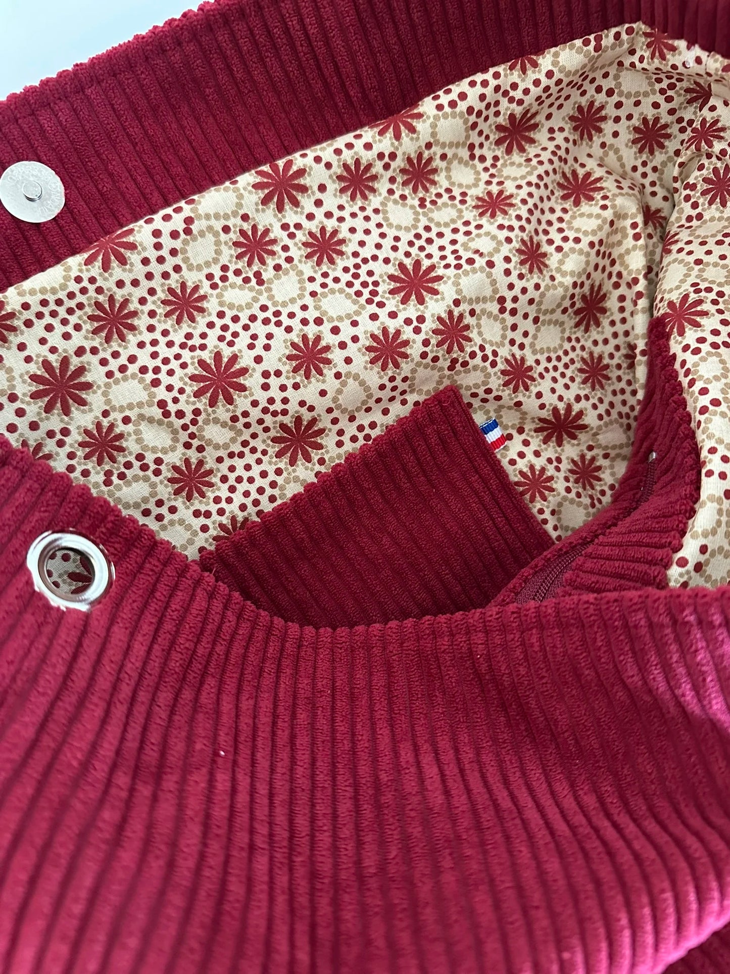 La poche plaquée intérieure du sac Hobo en velours cotelé bordeaux, et anse en cuir .