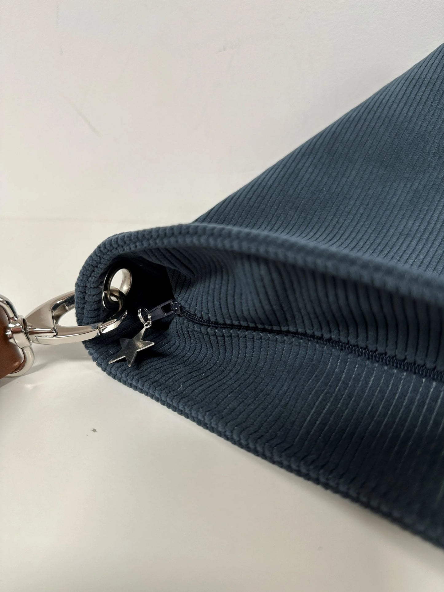 Le sac Hobo fermé par fermeture à glissière, ici visualisé sur le sac Hobo en velours cotelé bleu canard.