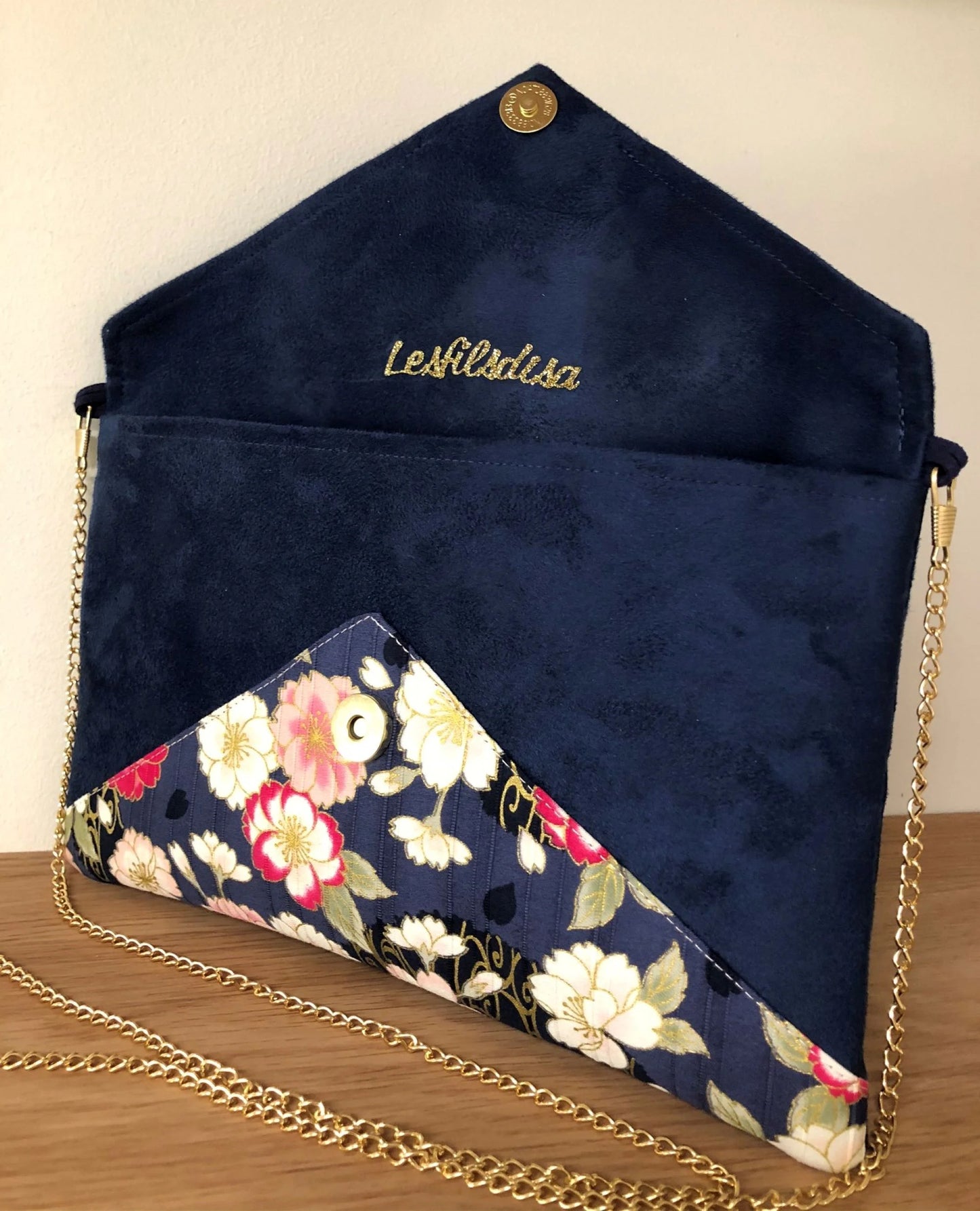 Le sac pochette Isa bleu marine avec tissu japonais fleuri et paillettes dorées, ouvert.