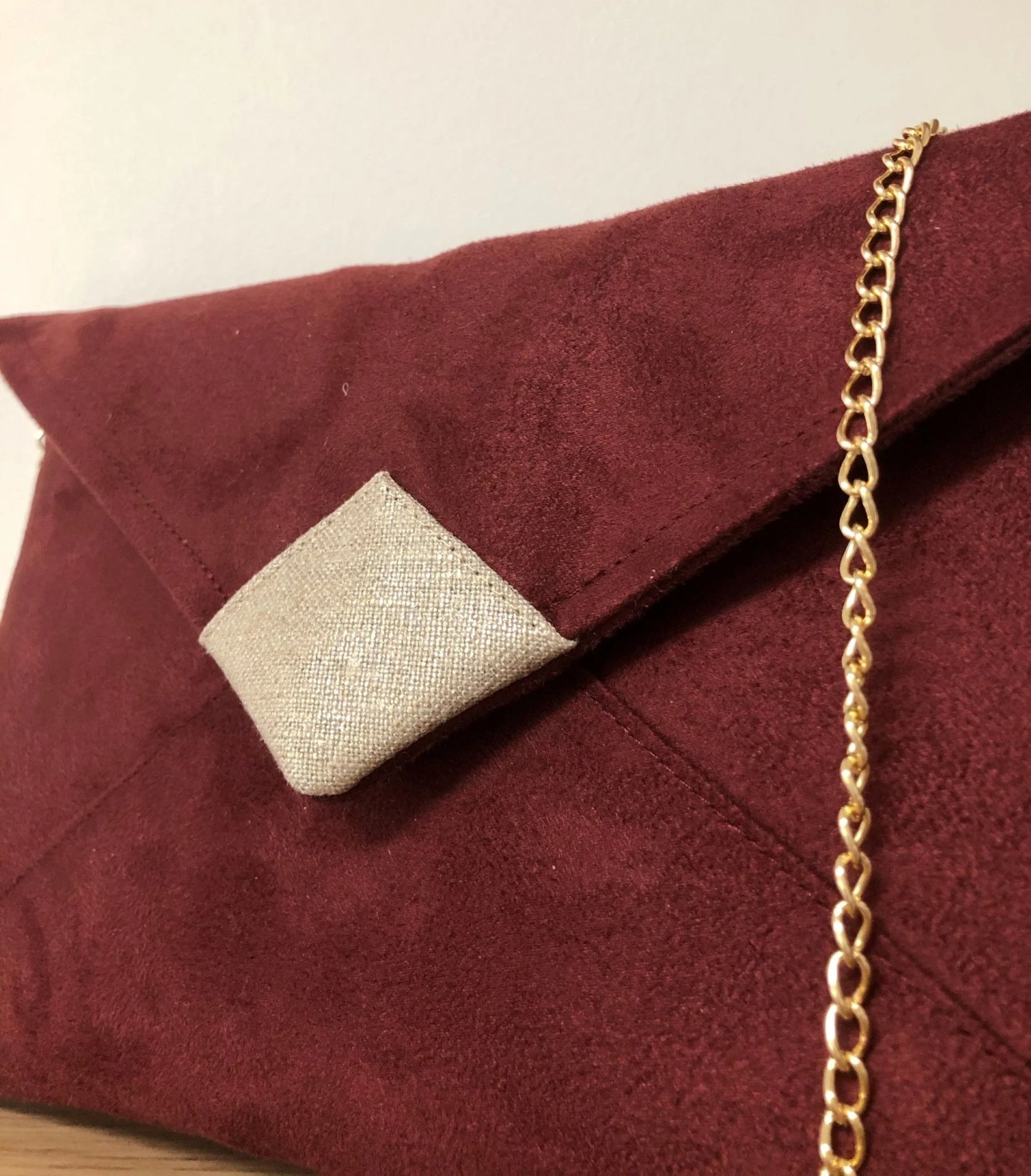 Vue détaillée du sac pochette Isa bordeaux et lin doré.