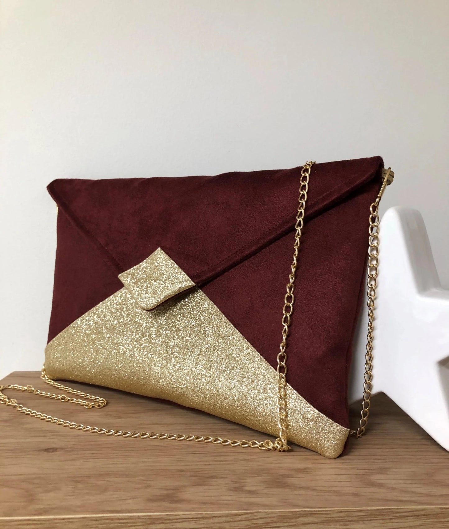 Le sac pochette Isa bordeaux à paillettes dorées, face avant.