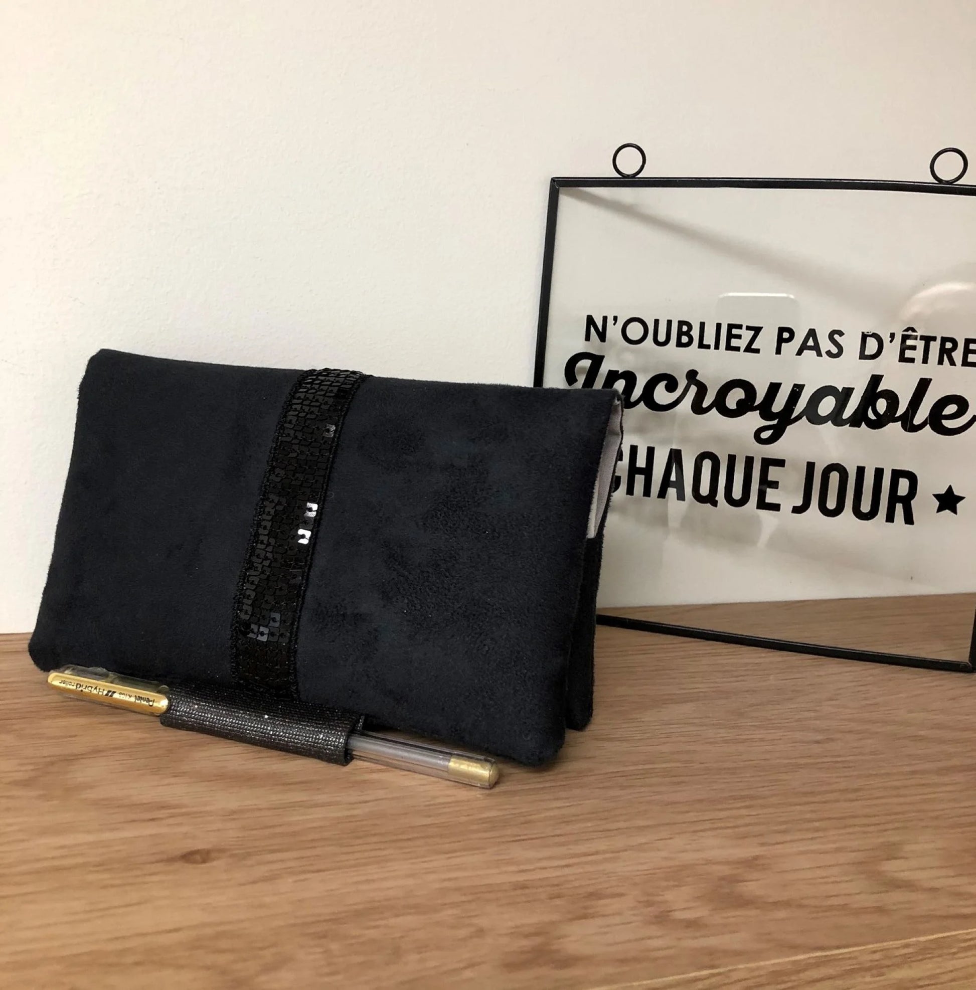 Le porte chéquier noir à paillettes avec porte stylo, vue de face.