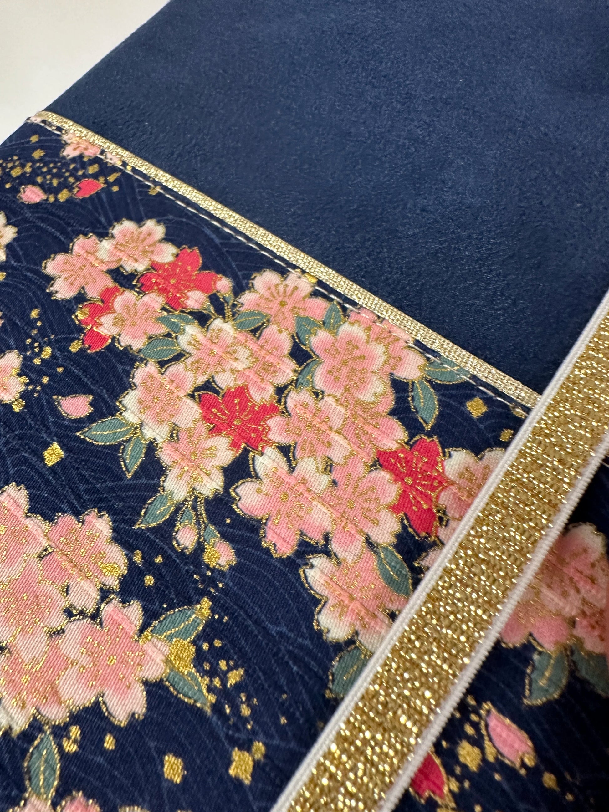 Vue détaillée du tissu japonais sur le protège-agenda bleu marine en tissu japonais fleuri.