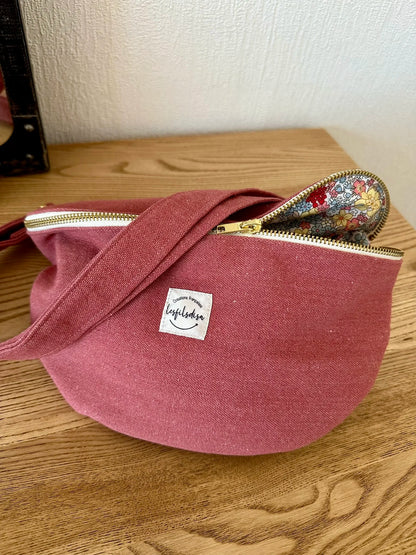 Vue d'ensemble du sac banane en toile framboise, entrouvert.