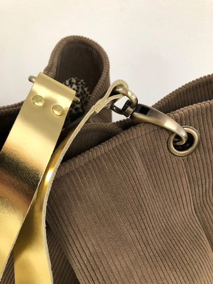 Vue détaillée du sac hobo en velours côtelé marron chamois et son anse en cuir doré