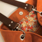 Vue de détail de l'intérieur du sac hobo Lesfilsdisa en velours côtelé orange et son anse en cuir marron amovible