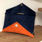 le sac pochette Isa bleu marine et orange à paillettes dorées, ouvert, avec chainette amovible.