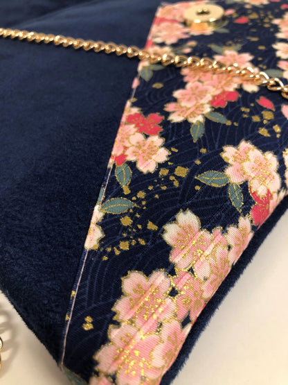 Vue détaillée du tissu japonais du sac pochette Isa bleu marine à fleurs de cerisier et paillettes dorées.