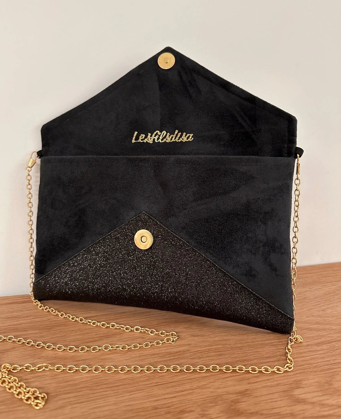 Le sac pochette Isa noir et doré à paillettes, ouvert.