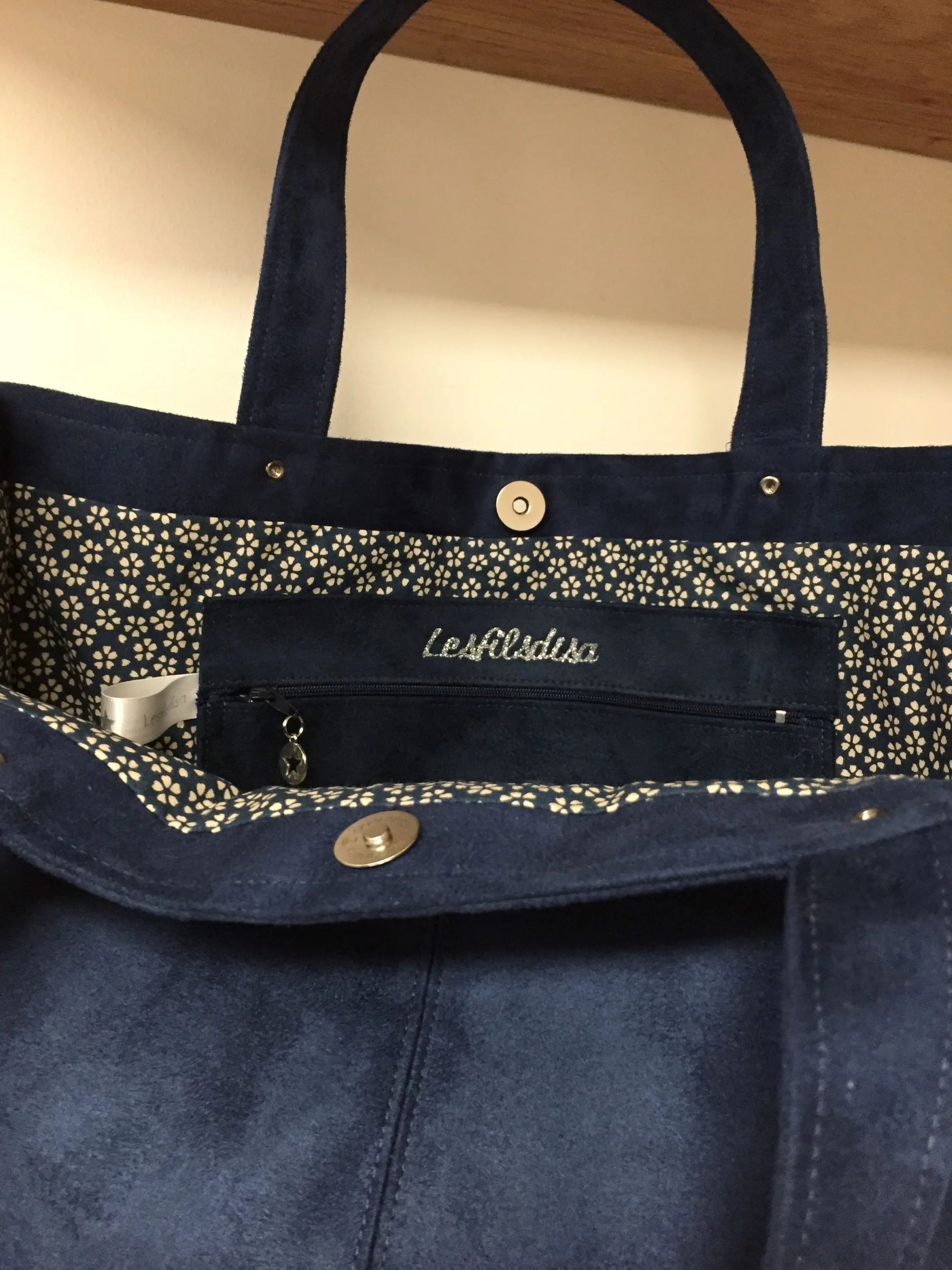 La poche plaquée intérieure du sac Shopper bleu marine .