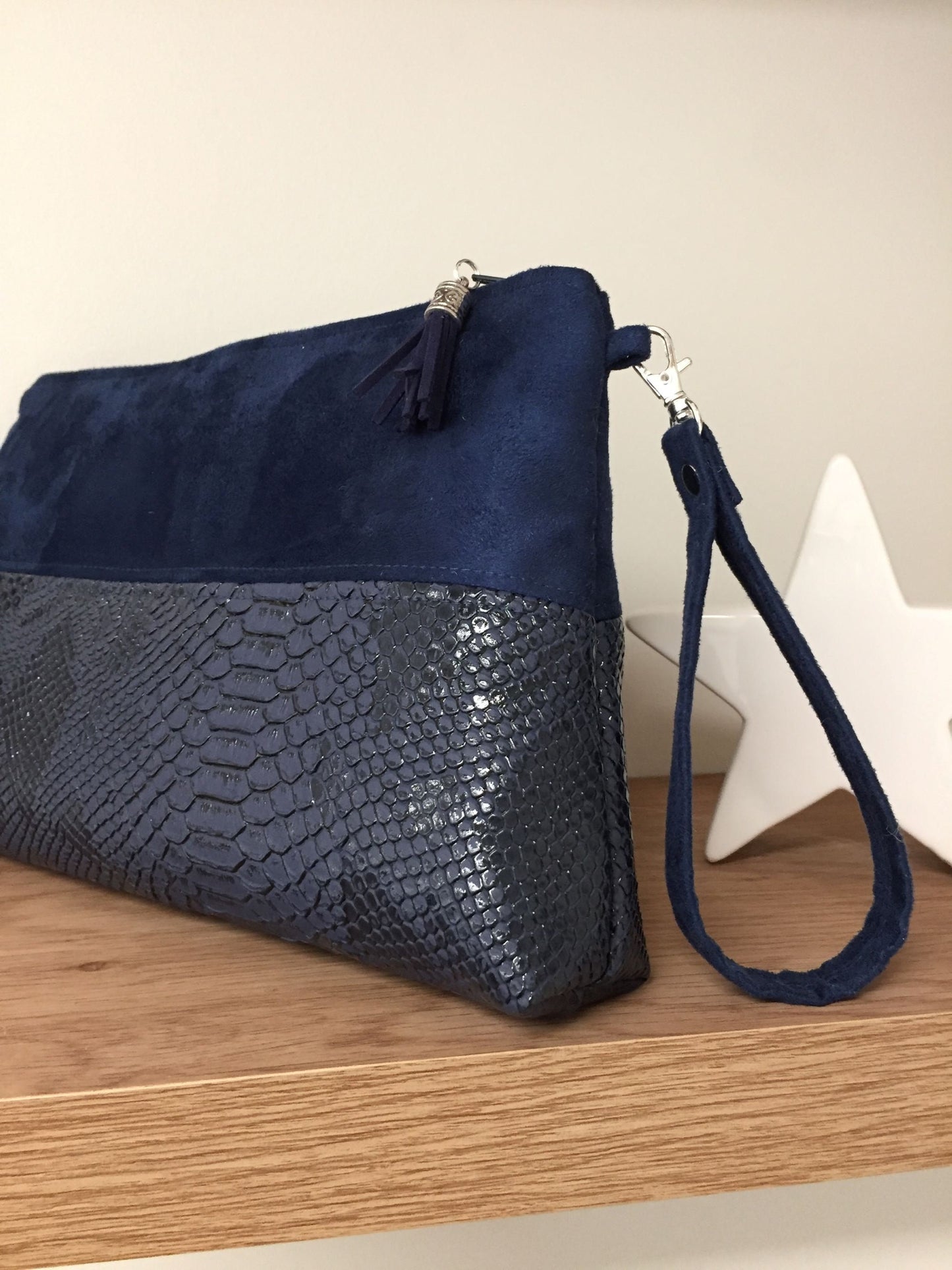 The Isa navy blue reptile-style zipped pouch with removable wrist strap