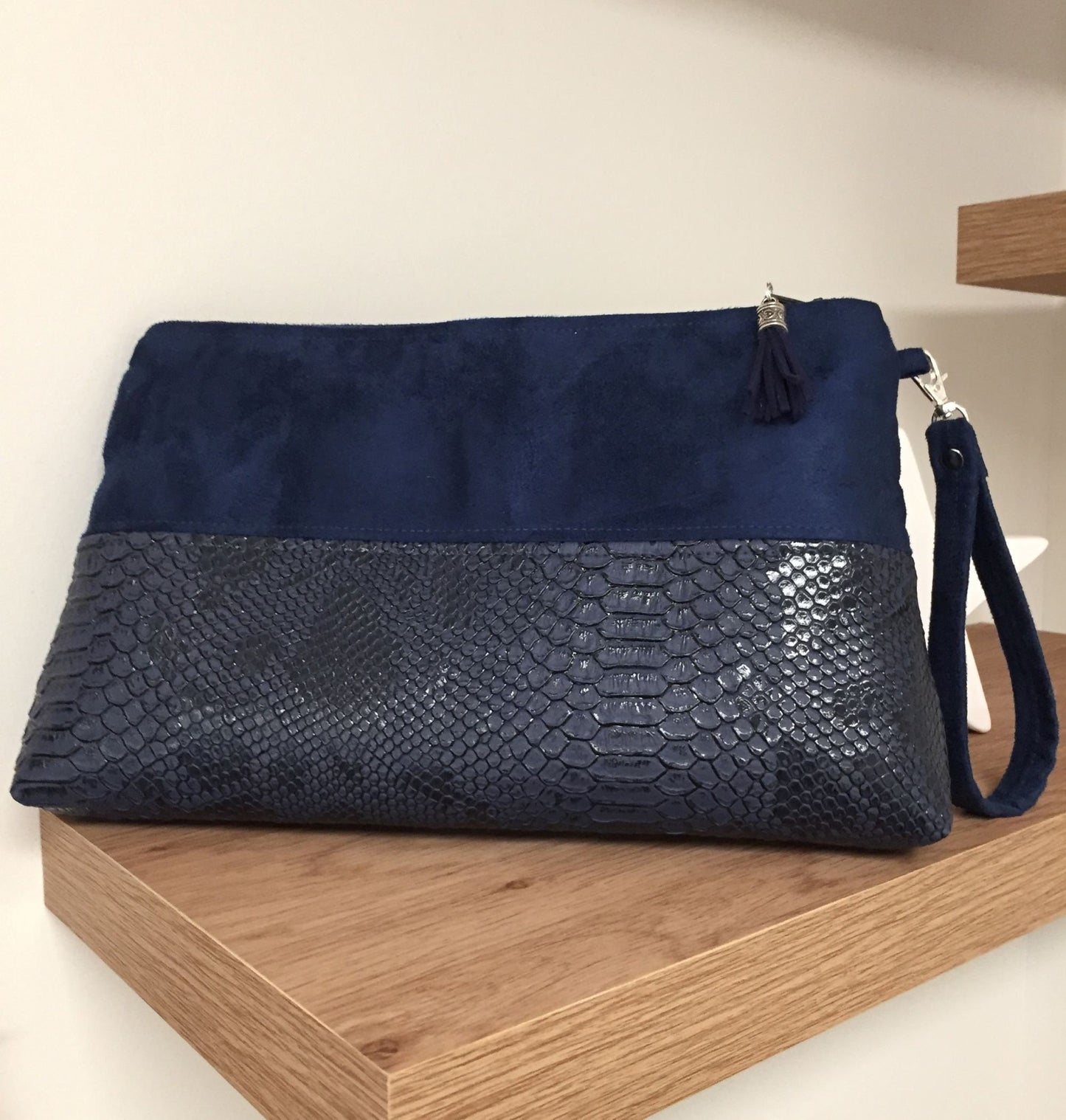 The Isa navy blue reptile-style zipped pouch with removable wrist strap
