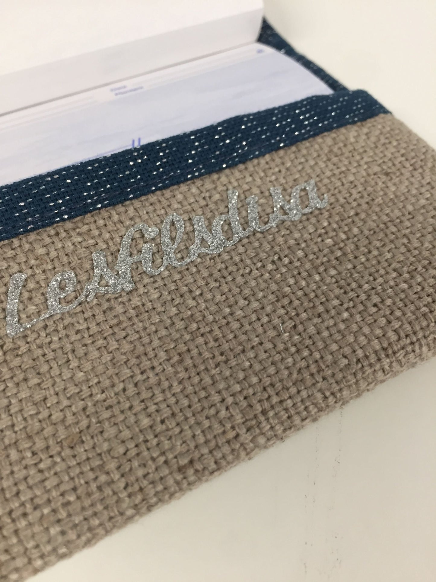 Beige and navy blue sequined checkbook holder with silver trim