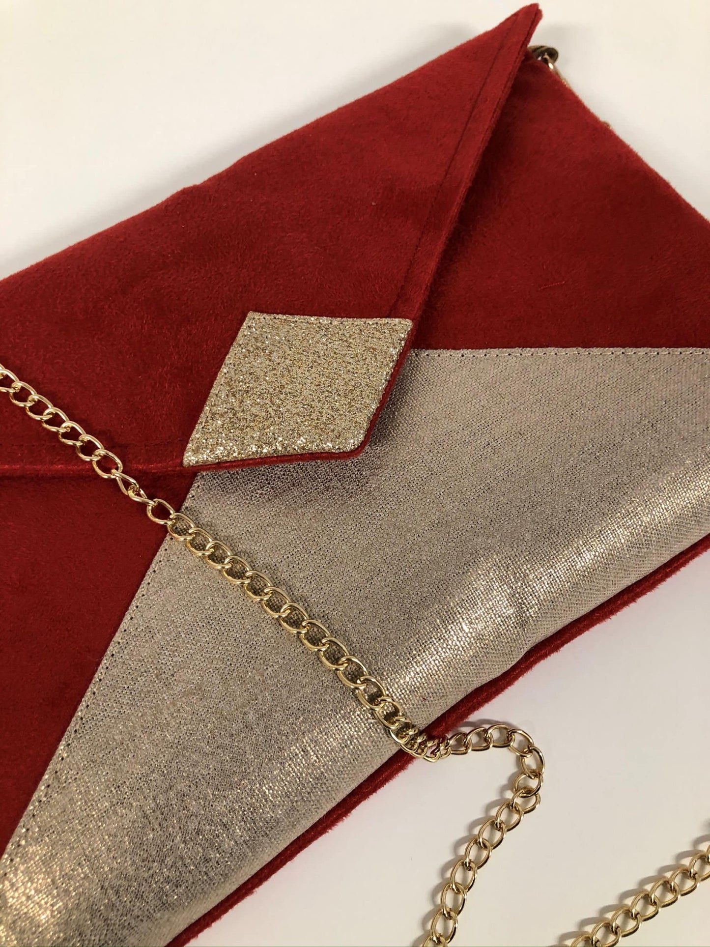 Red Isa clutch bag in linen and gold sequins