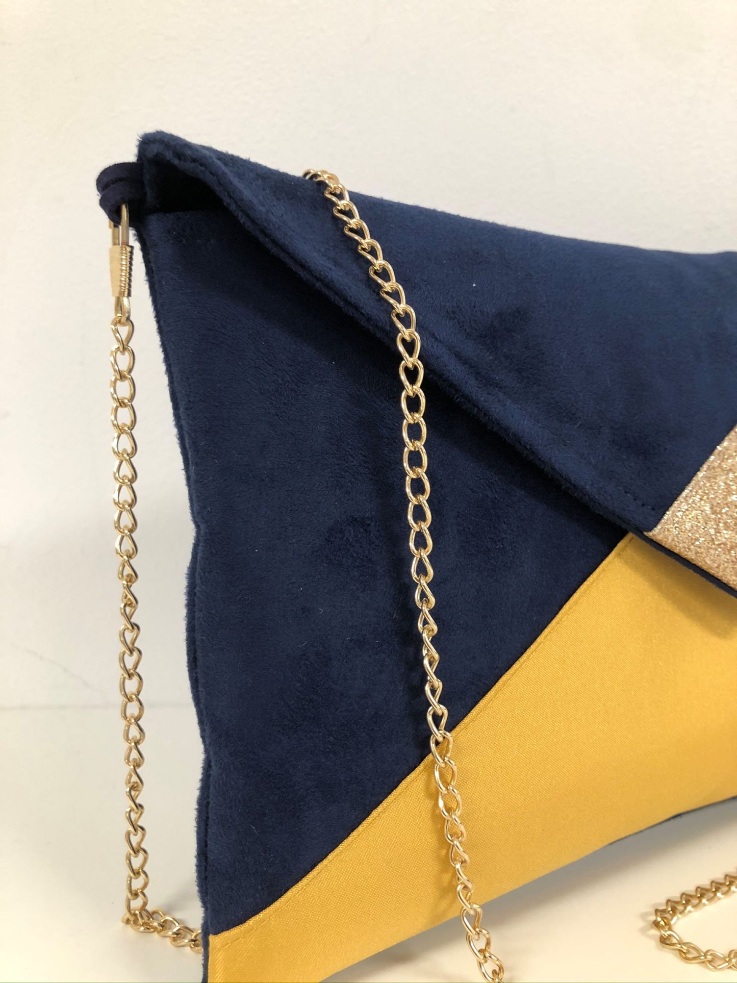 Navy blue and mustard yellow Isa clutch bag with gold sequins
