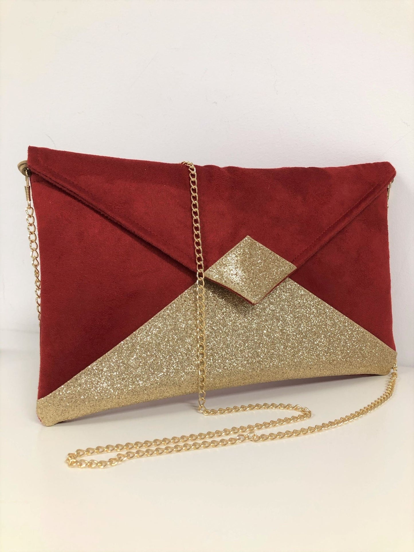 Red Isa clutch bag with gold sequins
