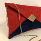 Red and navy blue Isa clutch bag with gold sequins