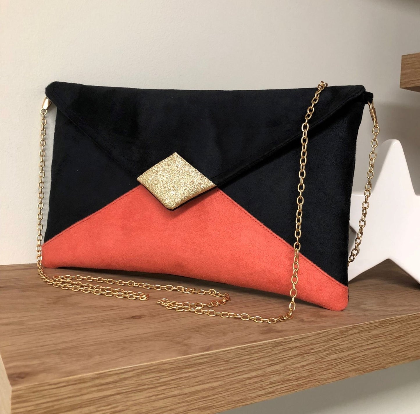 Black and coral Isa clutch bag with gold sequins