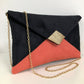 Black and coral Isa clutch bag with gold sequins