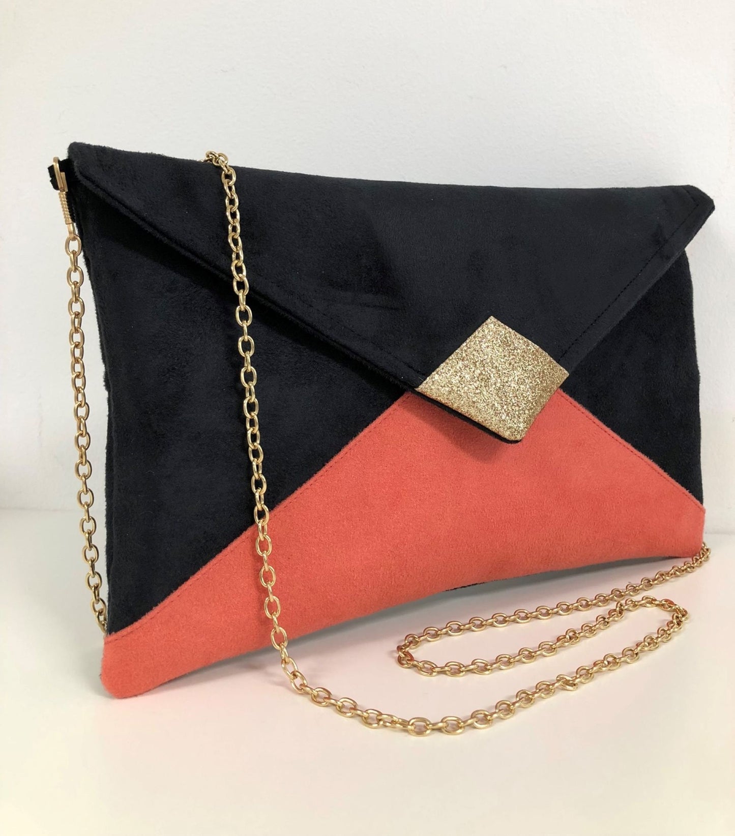 Black and coral Isa clutch bag with gold sequins
