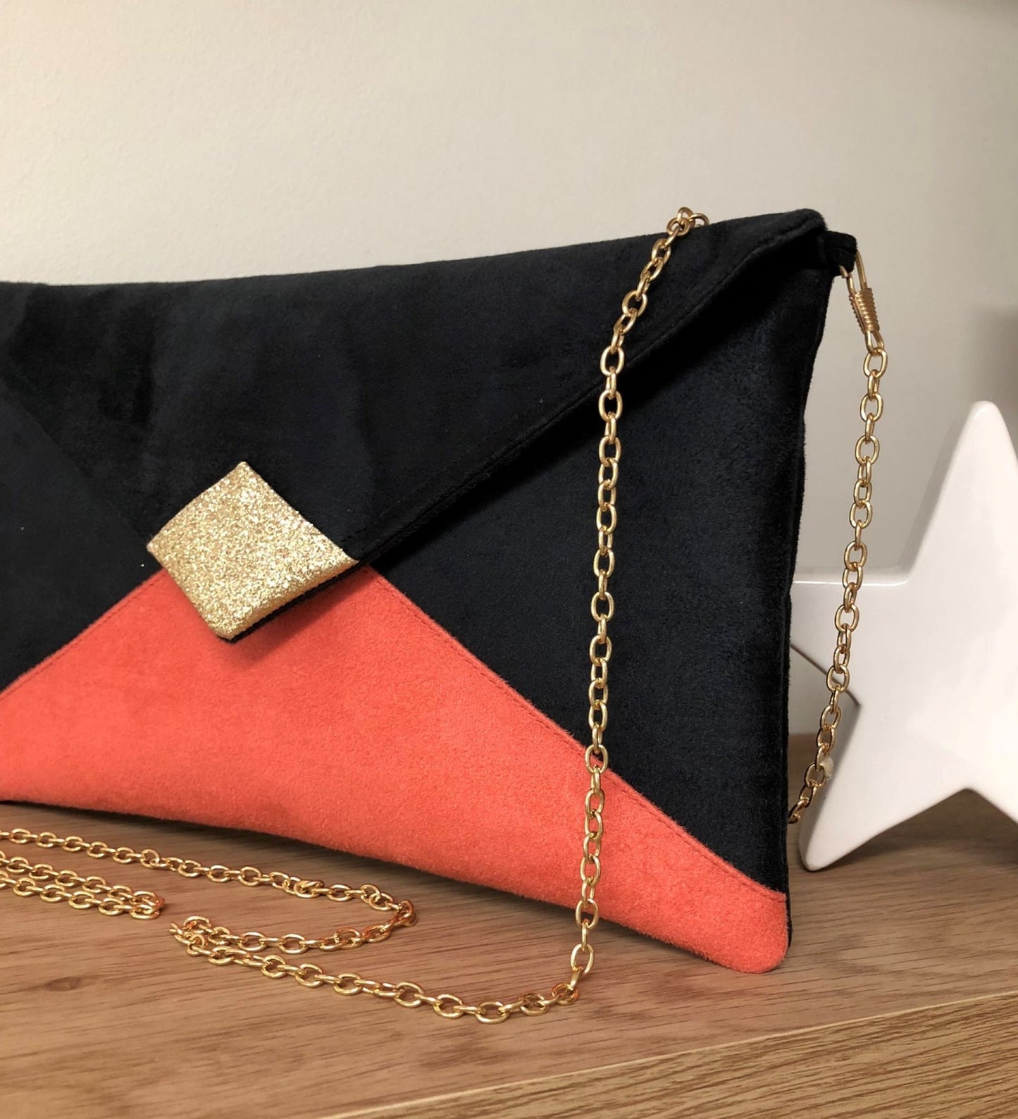 Black and coral Isa clutch bag with gold sequins