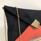 Black and coral Isa clutch bag with gold sequins